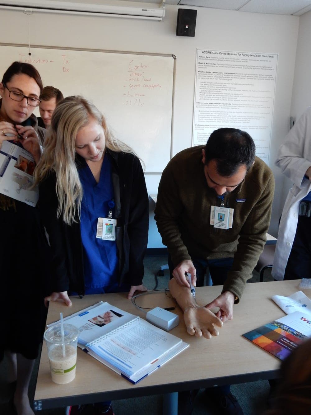 Two residents practicing injections