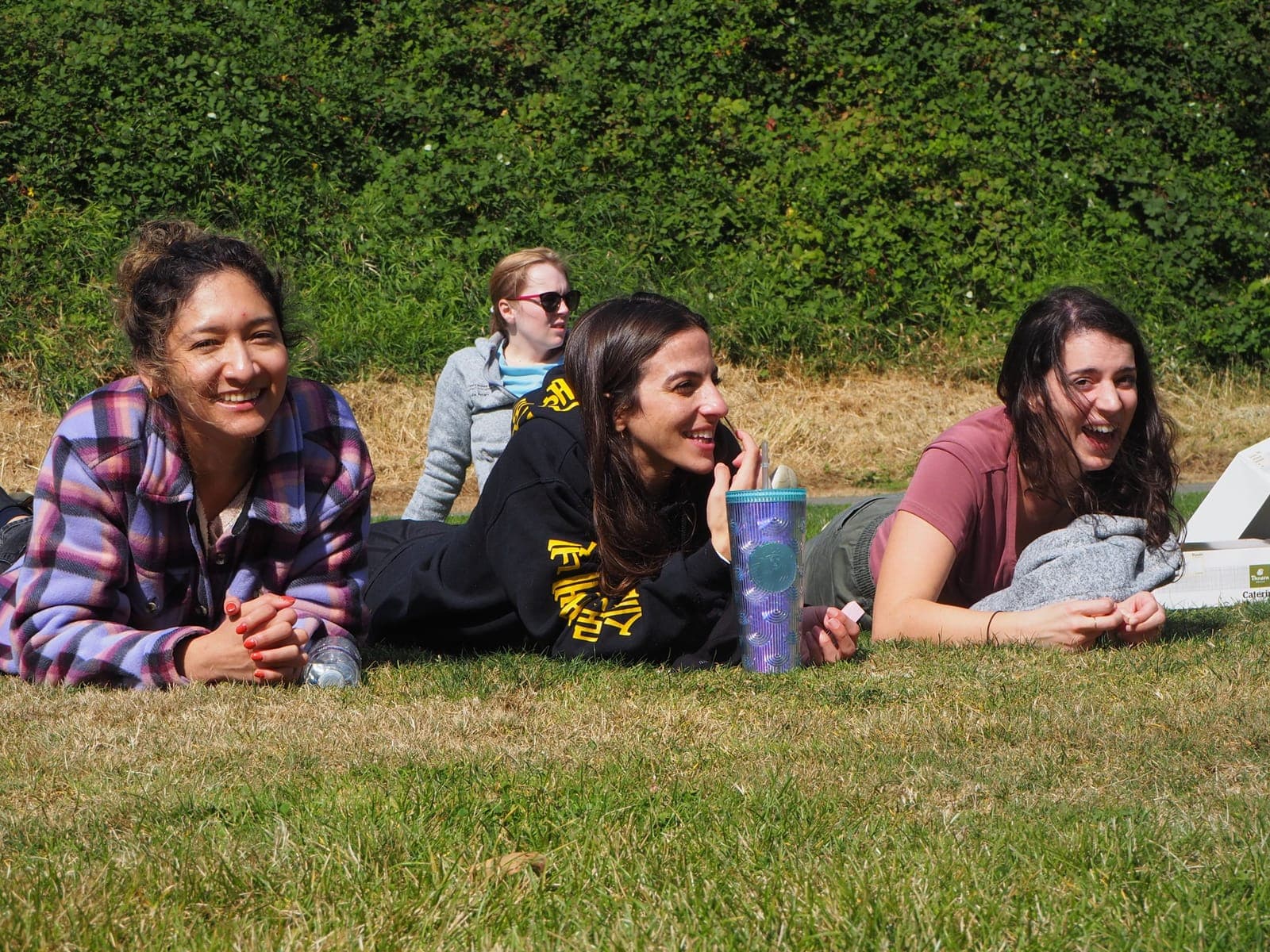 Residents lying on the grass laughing