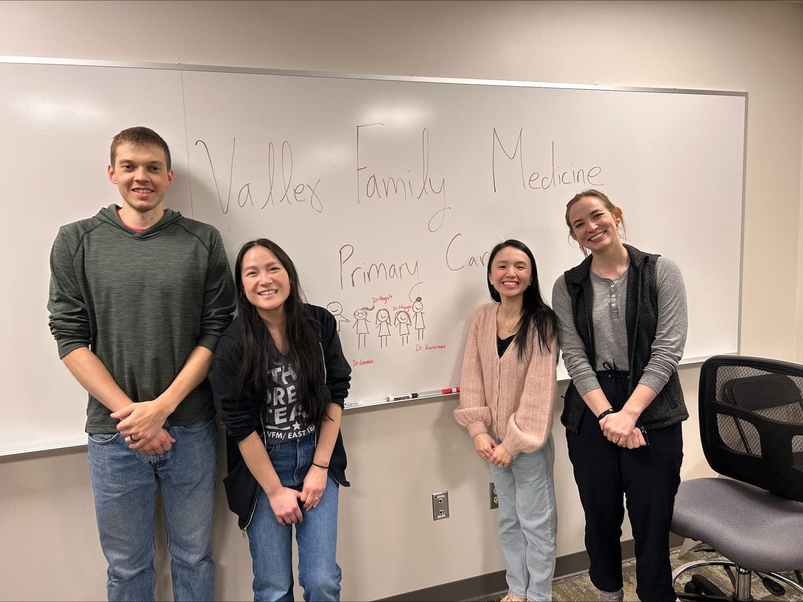 Four Valley Family Medicine residents in front of a whiteboard reading Valley Family Medicine, Primary Care