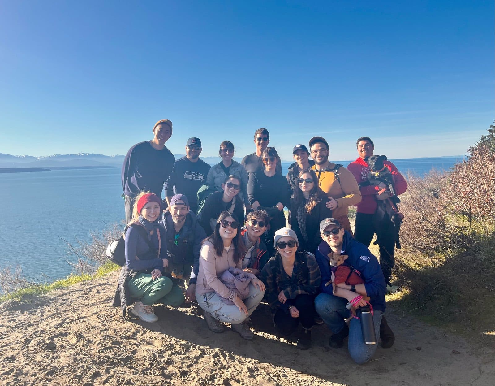 The class of 2027 and friends on a bluff-top trail above Puget Sound, with the Olympic Mountains across the water