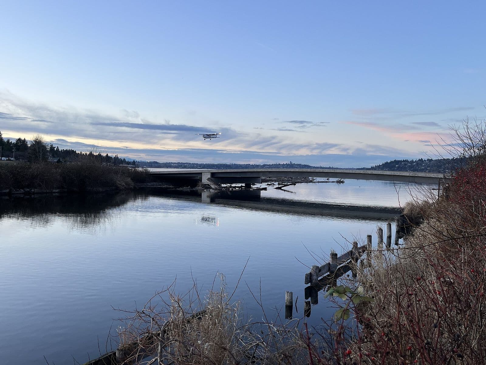The Cedar River where it meets Lake Washington at dusk, with a bridge in the distance