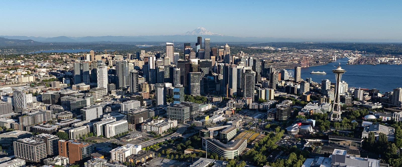 Aerial view of downtown Seattle and the Space Needle, with Mount Rainier on the horizon
